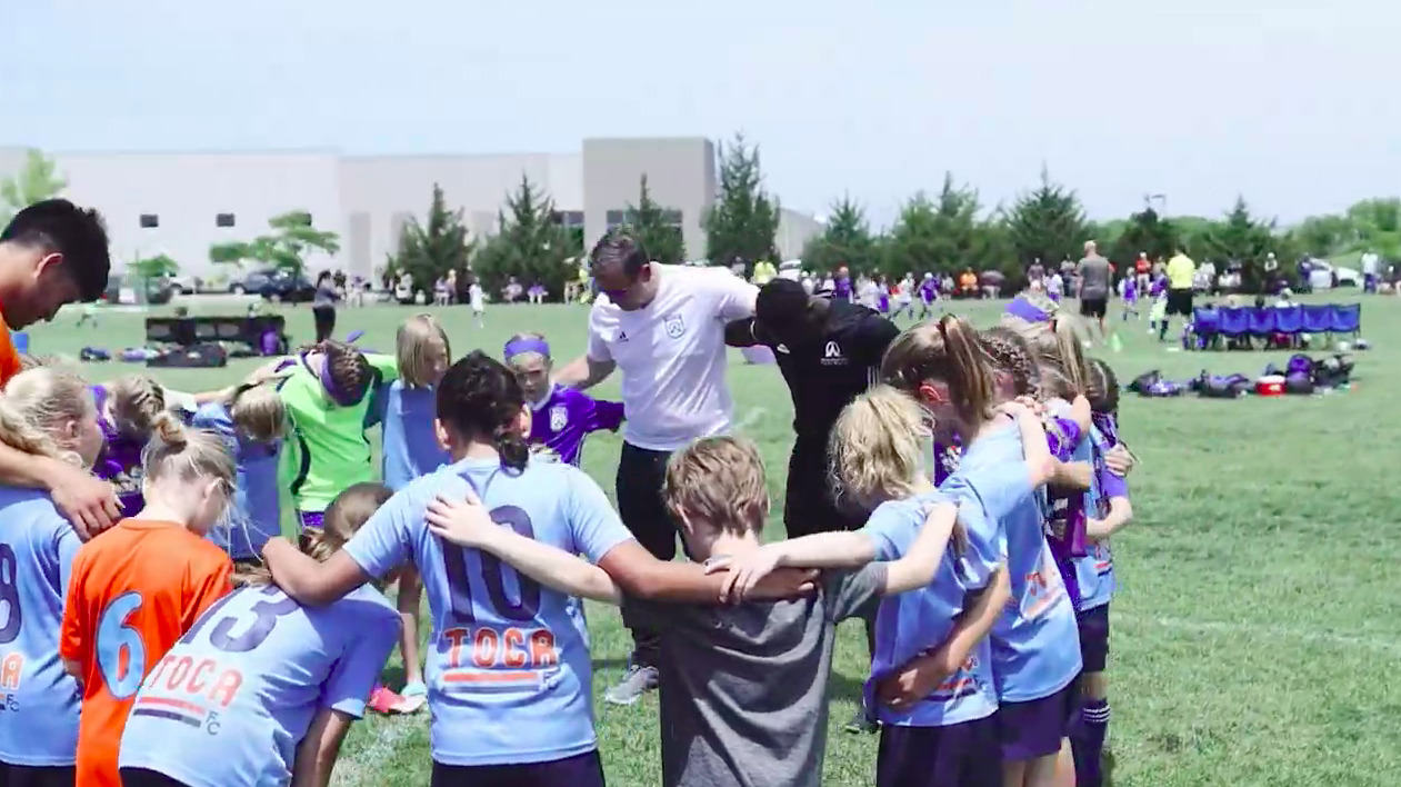 Coaches and players in a huddle