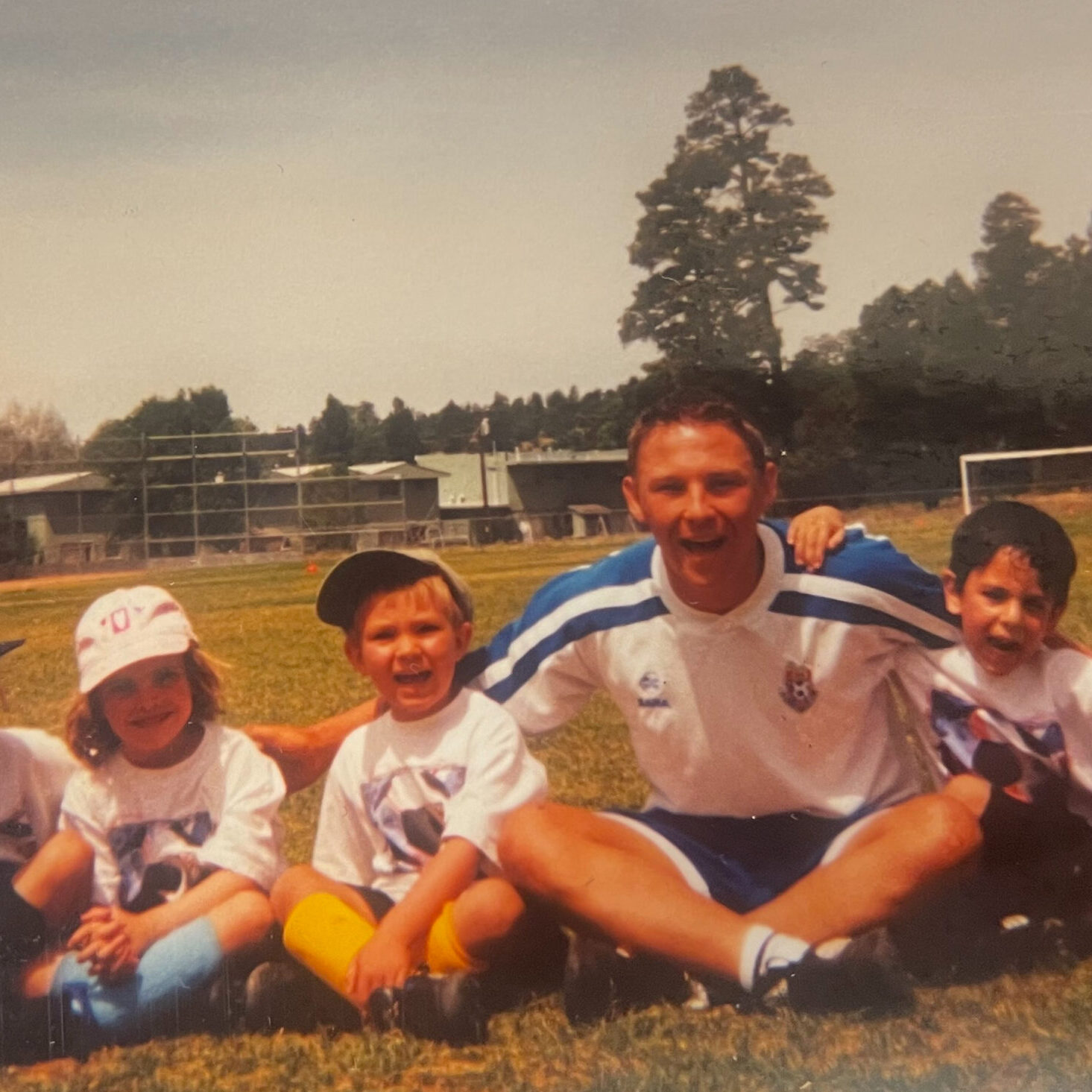 2001 Challenger Soccer Camp Photo with kids & young coach