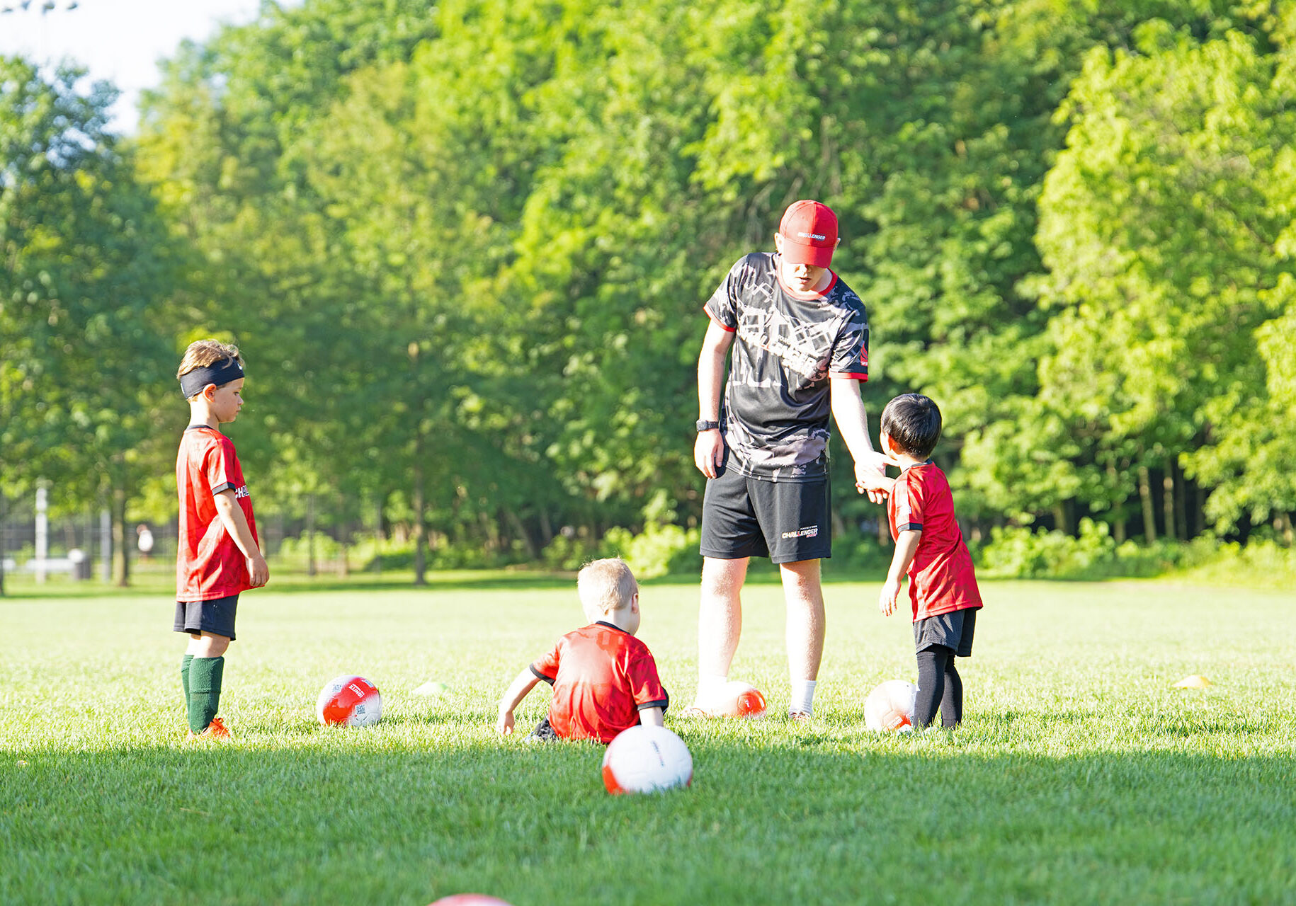 Coach building rapport with young soccer players on a camp