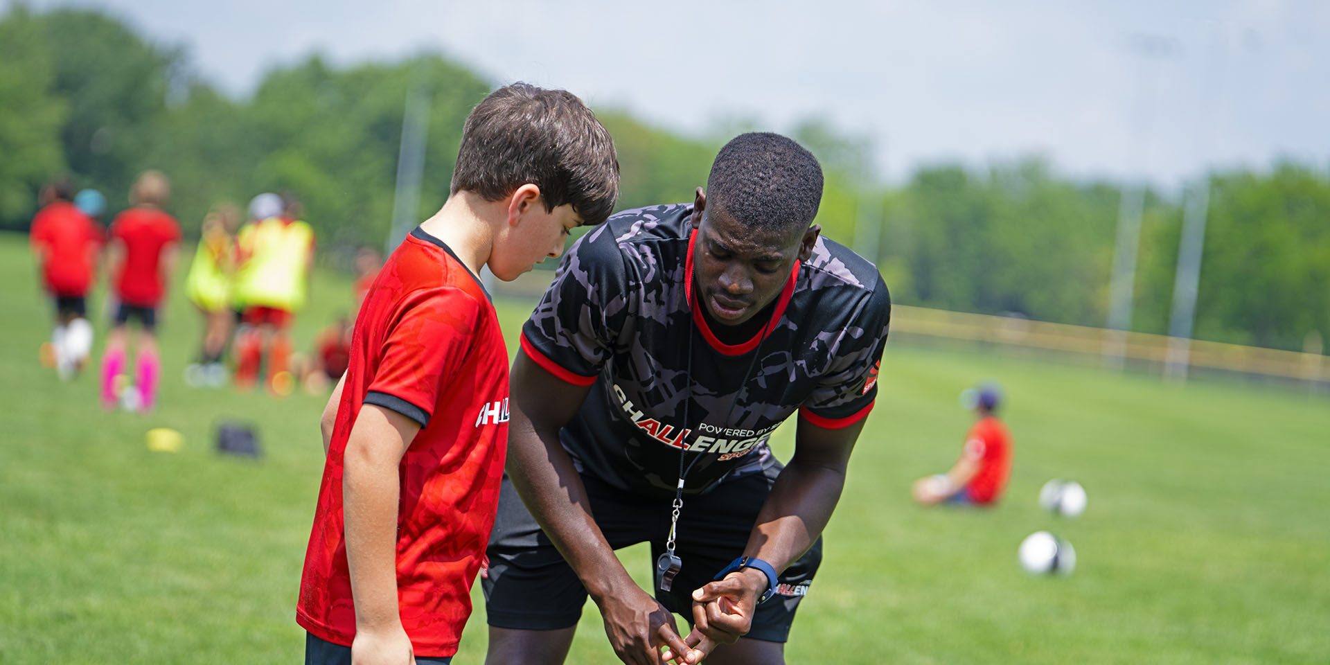 Coach talking to a young soccer player