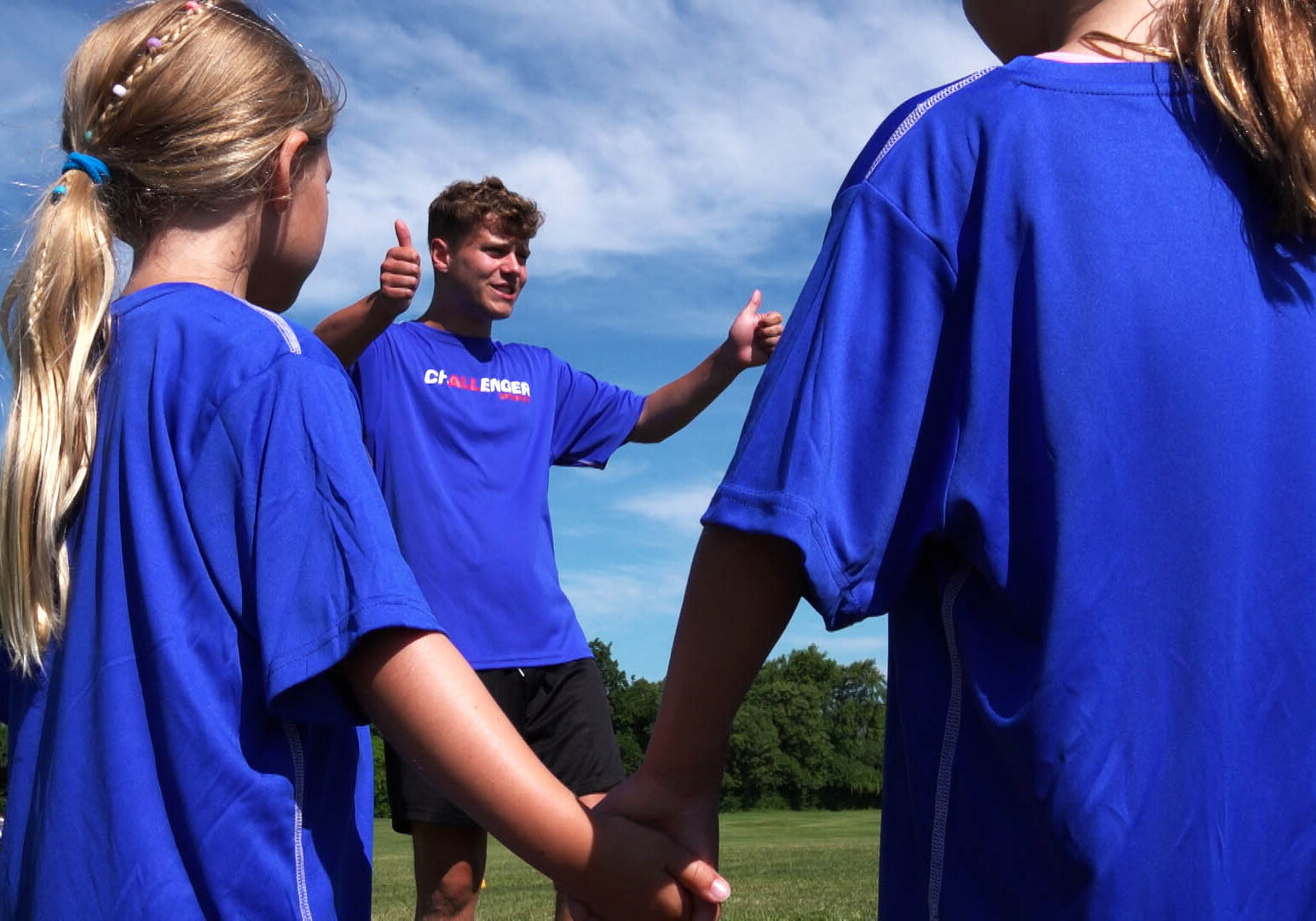 Coach giving campers a thumbs up on camp