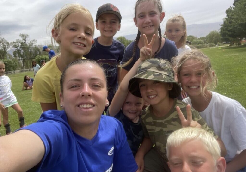 Coach taking a selfie with kids on camp