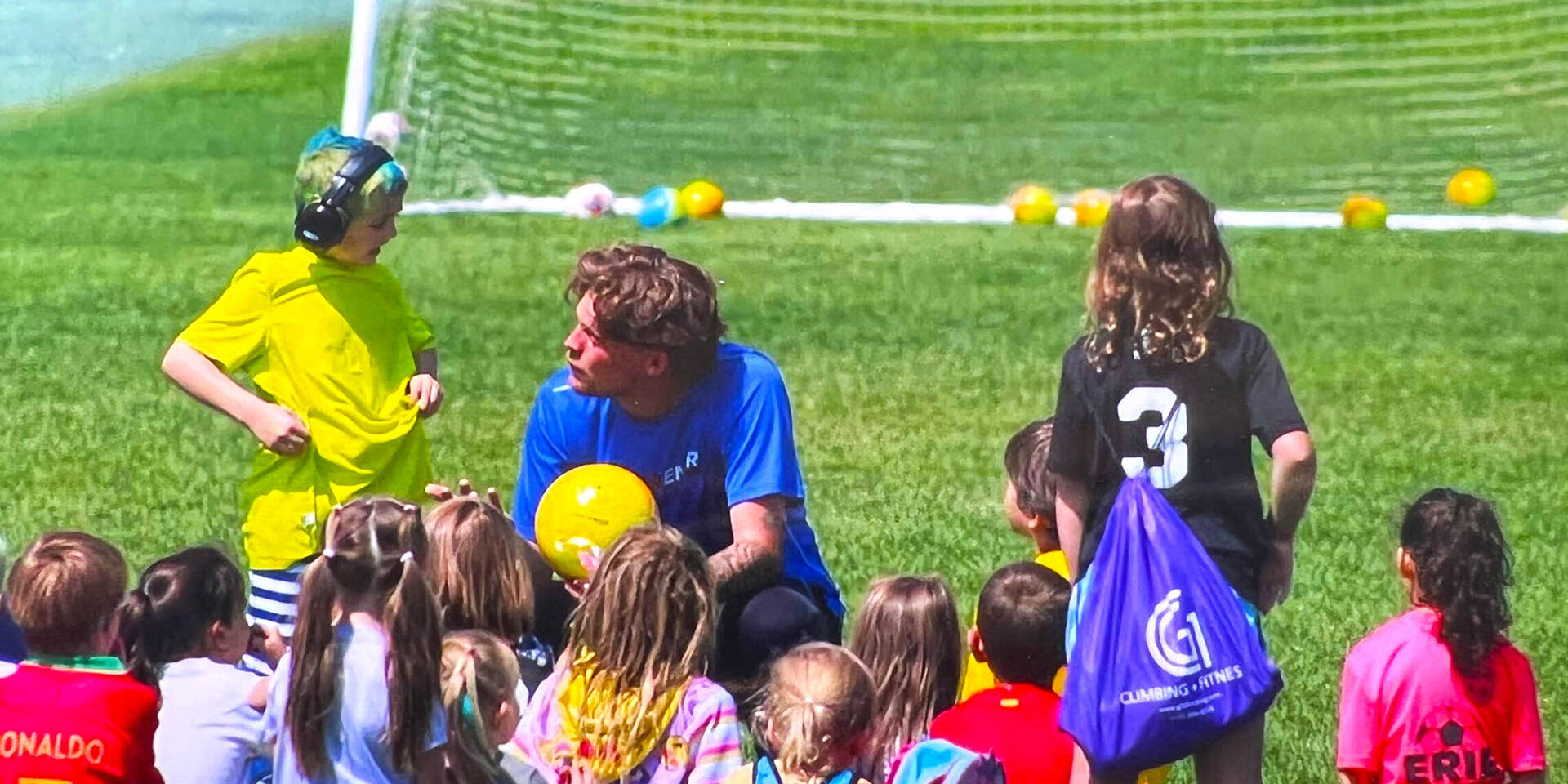 Coach talking with kids at the start of camp