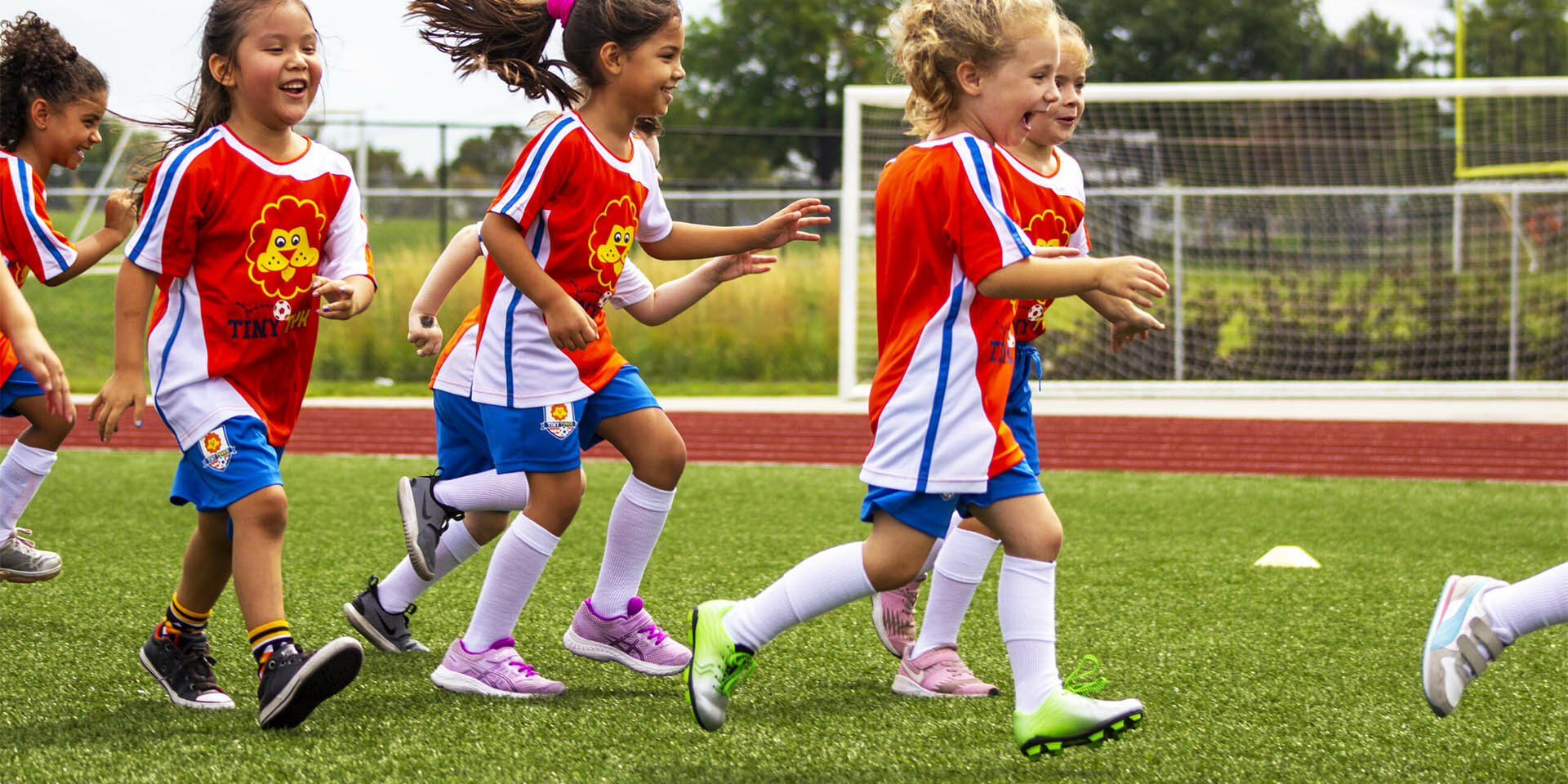 TinyTykes Young Players Running and Having Fun